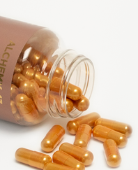 close up of GLP-1 vitamin bottle on its side with gold pill capsules spilling out